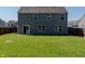 Large, lush backyard with a well-maintained lawn and a view of the home's exterior at 6491 Enclave Blvd, Greenwood, IN 46143