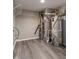 The unfinished basement has modern gray wood-look floors and updated utilities including a new hot water heater at 6491 Enclave Blvd, Greenwood, IN 46143