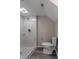 A full bathroom with a toilet and tiled walk-in shower with marble-look tile and accent tile at 6491 Enclave Blvd, Greenwood, IN 46143