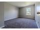 Carpeted bedroom with neutral paint, a window, and lots of natural light at 6491 Enclave Blvd, Greenwood, IN 46143