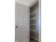 Walk-in closet with white wire shelving and a six-panel door at 6491 Enclave Blvd, Greenwood, IN 46143
