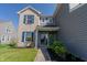Home featuring a combined brick and vinyl exterior with well-maintained landscaping and blue shutters at 6491 Enclave Blvd, Greenwood, IN 46143