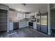 The kitchen offers stainless steel appliances, ample cabinet space and modern gray wood-look flooring at 6491 Enclave Blvd, Greenwood, IN 46143