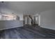 Open-concept living space with dark wood floors, neutral gray walls, and natural light throughout at 6491 Enclave Blvd, Greenwood, IN 46143
