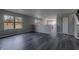 Bright living room with dark wood flooring, and neutral gray walls, leading into the kitchen at 6491 Enclave Blvd, Greenwood, IN 46143