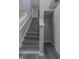 Staircase with freshly painted white trim, gray walls, and sleek, contemporary gray wood stairs at 6491 Enclave Blvd, Greenwood, IN 46143