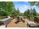 Spacious wood deck with outdoor furniture and scenic backyard views at 665 Spring Hills Dr, Zionsville, IN 46077