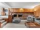 Finished basement area with a brick fireplace, wood paneling, and comfortable seating at 665 Spring Hills Dr, Zionsville, IN 46077