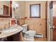Cozy bathroom with granite countertop vanity, decorative wall mirror and warm, earth-tone tile at 665 Spring Hills Dr, Zionsville, IN 46077