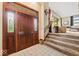 Elegant entryway with tiled floor, decorative door, and staircase leading to upstairs at 665 Spring Hills Dr, Zionsville, IN 46077