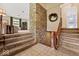 Grand foyer with stone accent wall, tiled floor, and staircase leading to upper levels at 665 Spring Hills Dr, Zionsville, IN 46077