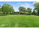 Expansive front yard featuring well-maintained lawn and mature trees surrounding property at 665 Spring Hills Dr, Zionsville, IN 46077