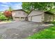 Detached garage with multiple bays, stone accents, and ample parking space at 665 Spring Hills Dr, Zionsville, IN 46077