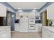 Updated kitchen with white cabinets, modern appliances, and recessed lighting at 665 Spring Hills Dr, Zionsville, IN 46077