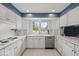 Bright kitchen with white cabinets, stainless steel appliances, and a window above the sink at 665 Spring Hills Dr, Zionsville, IN 46077