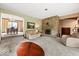 Cozy living room with stone fireplace, comfortable seating, and seamless access to dining area at 665 Spring Hills Dr, Zionsville, IN 46077