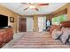 Main bedroom with hardwood furniture, ceiling fan, and an ensuite bathroom at 665 Spring Hills Dr, Zionsville, IN 46077