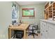 Inviting home office featuring a wood desk, comfortable chair, natural light, and neutral decor at 665 Spring Hills Dr, Zionsville, IN 46077
