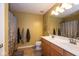 Bright bathroom featuring double vanity sinks, decorative mirror, and a shower with patterned curtain at 6683 School Branch Dr, Brownsburg, IN 46112