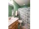 Well-lit bathroom with a single vanity, mirror, and shower-tub combination at 6683 School Branch Dr, Brownsburg, IN 46112