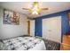 Well-lit bedroom with a ceiling fan, painting and stylish patterned rug at 6683 School Branch Dr, Brownsburg, IN 46112