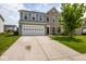 Charming two-story home featuring stone accents, a two-car garage, and a well-manicured front yard at 6683 School Branch Dr, Brownsburg, IN 46112