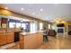 Bright open concept kitchen with granite countertops, wooden cabinets, and breakfast bar open to the living room at 6683 School Branch Dr, Brownsburg, IN 46112