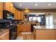 Kitchen featuring granite countertops, stainless steel appliances, and wooden cabinetry overlooking the breakfast nook at 6683 School Branch Dr, Brownsburg, IN 46112