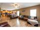 Spacious living room with wood flooring and modern furnishings flowing into the kitchen at 6683 School Branch Dr, Brownsburg, IN 46112