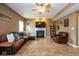 Cozy living room with a fireplace, a large comfortable sectional sofa, and neutral decor at 6683 School Branch Dr, Brownsburg, IN 46112