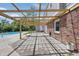 Inviting backyard featuring a pergola-covered patio, brick accents, and steps to the pool at 6839 Chaucer Ct, Indianapolis, IN 46220