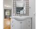 Bright bathroom vanity with decorative mirror and stylish patterned tile wall at 6839 Chaucer Ct, Indianapolis, IN 46220
