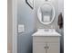 Charming powder room with penny tile accent wall, white vanity, and updated fixtures at 6839 Chaucer Ct, Indianapolis, IN 46220