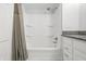 Bright bathroom features a shower-tub combo with built-in shelves and a neutral color palette at 6839 Chaucer Ct, Indianapolis, IN 46220