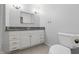 Bathroom featuring a vanity with granite counters, a modern toilet, and neutral walls at 6839 Chaucer Ct, Indianapolis, IN 46220