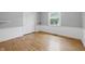 Bright bedroom featuring hardwood floors, white wainscoting, and neutral walls at 6839 Chaucer Ct, Indianapolis, IN 46220