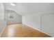 An attic bedroom featuring hardwood floors, a window, and a closet door at 6839 Chaucer Ct, Indianapolis, IN 46220