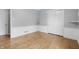 Bedroom featuring hardwood floors, white wainscoting, and closet with sliding doors at 6839 Chaucer Ct, Indianapolis, IN 46220
