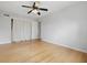 Bedroom with hardwood floors, ceiling fan, and sliding closet doors at 6839 Chaucer Ct, Indianapolis, IN 46220