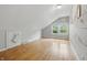 Bedroom featuring hardwood floors, fresh paint, a window, and a closet door at 6839 Chaucer Ct, Indianapolis, IN 46220