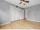 Bedroom with hardwood floors, ceiling fan, closet with sliding doors and white trim at 6839 Chaucer Ct, Indianapolis, IN 46220
