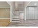 Foyer view showing the transition from hardwood to new tile floors and the staircase to the second floor at 6839 Chaucer Ct, Indianapolis, IN 46220