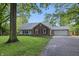Traditional home with brick accents, an attached garage, and a well-manicured front lawn at 6839 Chaucer Ct, Indianapolis, IN 46220