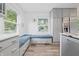 Eat-in kitchen featuring stainless steel appliances, gray cabinets, and built-in bench at 6839 Chaucer Ct, Indianapolis, IN 46220