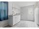 Bright laundry room features white cabinets, granite countertop, shelving, and wood-look tile flooring at 6839 Chaucer Ct, Indianapolis, IN 46220