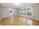 Spacious living room featuring hardwood floors and a view into the bright, remodeled kitchen at 6839 Chaucer Ct, Indianapolis, IN 46220
