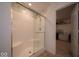 Modern bathroom with a glass-enclosed shower stall and a view into the walk-in closet at 7234 Darley Ln, Indianapolis, IN 46259
