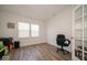 Bright, versatile room with wood floors, a large window, and classic chair at 7234 Darley Ln, Indianapolis, IN 46259