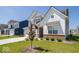 Attractive two-story home with manicured lawn and young tree in a residential neighborhood at 7234 Darley Ln, Indianapolis, IN 46259