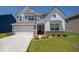 Charming two-story home with a two-car garage and well-manicured lawn at 7234 Darley Ln, Indianapolis, IN 46259